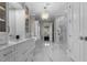 A bright bathroom features marble floors, a double vanity, and a marble shower at 1416 Bailey Hill Dr, Raleigh, NC 27614