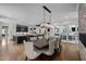 Open-concept dining area adjacent to the kitchen, fireplace, and glass doors leading to the deck at 1416 Bailey Hill Dr, Raleigh, NC 27614