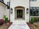 Elegant front entrance with stone walkway, custom door and manicured landscaping at 1416 Bailey Hill Dr, Raleigh, NC 27614