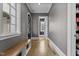 Hallway with hardwood floors, bench seating and natural light, providing a welcoming transition at 1416 Bailey Hill Dr, Raleigh, NC 27614