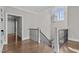 A bright hallway features hardwood floors and a modern light fixture at 1416 Bailey Hill Dr, Raleigh, NC 27614