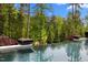 Infinity pool with fire bowls and lush landscaping, creating a serene outdoor oasis at 1416 Bailey Hill Dr, Raleigh, NC 27614