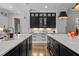Beautiful kitchen with black and white cabinets and two islands with marble countertops at 1416 Bailey Hill Dr, Raleigh, NC 27614