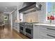 Luxury kitchen featuring a Wolf stainless steel range and custom vent hood at 1416 Bailey Hill Dr, Raleigh, NC 27614