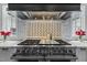 Close up of range showing Wolf range with custom vent hood and marble backsplash at 1416 Bailey Hill Dr, Raleigh, NC 27614