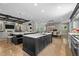 Open kitchen with large islands, stainless appliances, view into living room and dining area at 1416 Bailey Hill Dr, Raleigh, NC 27614