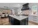 Open kitchen with a large island, stainless steel appliances, and black cabinets at 1416 Bailey Hill Dr, Raleigh, NC 27614