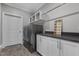 Well-organized laundry room featuring modern washer/dryer, storage cabinets, and a laundry schedule sign at 1416 Bailey Hill Dr, Raleigh, NC 27614