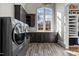 This laundry room features dark wood cabinets and modern machines at 1416 Bailey Hill Dr, Raleigh, NC 27614