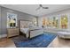 A beautifully staged main bedroom offers a comfortable king bed and windows to a beautiful backyard at 1416 Bailey Hill Dr, Raleigh, NC 27614