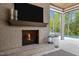 Outdoor fireplace with a view of the pool and backyard at 1416 Bailey Hill Dr, Raleigh, NC 27614