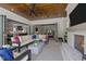 Inviting outdoor living space with fireplace, ceiling fan, and open access to the indoors at 1416 Bailey Hill Dr, Raleigh, NC 27614