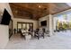 Inviting covered outdoor living area with fireplace, wood ceiling, and comfortable seating at 1416 Bailey Hill Dr, Raleigh, NC 27614
