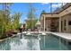Luxury pool with tanning ledges, two lounge chairs and an outdoor kitchen with dining space at 1416 Bailey Hill Dr, Raleigh, NC 27614
