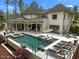Luxury home featuring a stunning pool, spa, and outdoor dining area with covered seating and an outdoor kitchen at 1416 Bailey Hill Dr, Raleigh, NC 27614