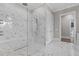 A gorgeous marble shower is enclosed in frameless glass at 1416 Bailey Hill Dr, Raleigh, NC 27614