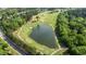 Aerial view of golf course and lake with surrounding neighborhood at 1416 Heritage Links Dr, Wake Forest, NC 27587