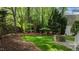 Manicured backyard featuring lawn, fire pit and wooded perimeter at 1416 Heritage Links Dr, Wake Forest, NC 27587