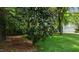 Backyard with lush landscaping and view of the garage at 1416 Heritage Links Dr, Wake Forest, NC 27587