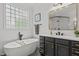 This bathroom features a sleek standalone tub, vanity, and natural light from a window at 1416 Heritage Links Dr, Wake Forest, NC 27587