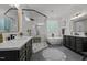 Bright bathroom featuring dual vanities, standalone tub, and glass-enclosed shower at 1416 Heritage Links Dr, Wake Forest, NC 27587