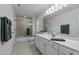 Spacious bathroom featuring double sinks, a large mirror, and a shower/tub with glass door at 1416 Heritage Links Dr, Wake Forest, NC 27587