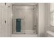 Bathroom featuring tub with glass door and light grey tile at 1416 Heritage Links Dr, Wake Forest, NC 27587