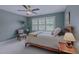 Cozy bedroom with wood bed frame, ceiling fan, and a large window with natural light at 1416 Heritage Links Dr, Wake Forest, NC 27587