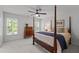Serene bedroom with four-poster bed, antique chest, and ample natural light from the window at 1416 Heritage Links Dr, Wake Forest, NC 27587