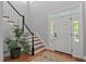 Welcoming entryway with hardwood floors, staircase, and natural light from sidelight windows at 1416 Heritage Links Dr, Wake Forest, NC 27587