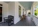 Covered front porch with chairs, bench and white railing at 1416 Heritage Links Dr, Wake Forest, NC 27587