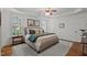 Well-lit main bedroom offers cozy rug, ceiling fan, shuttered windows and wood flooring at 1416 Heritage Links Dr, Wake Forest, NC 27587