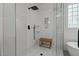 Glass enclosed shower features white tile walls, a shower seat, and a modern showerhead at 1416 Heritage Links Dr, Wake Forest, NC 27587