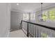 Bright staircase with gray walls, white trim, and black handrail leading to upper level at 1416 Heritage Links Dr, Wake Forest, NC 27587