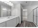 Bright bathroom featuring modern vanity with large mirror and glass enclosed shower at 145 Gladstone Loop, Clayton, NC 27520
