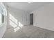 Spacious bedroom featuring plush carpeting, a window, and a closet at 145 Gladstone Loop, Clayton, NC 27520