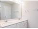 Bright bathroom featuring double sinks, a large mirror, and white cabinets and walls at 147 Little Crk Dr, Lillington, NC 27546