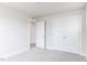 This bedroom features neutral walls, plush carpet, double closets, and a doorway to the bathroom at 147 Little Crk Dr, Lillington, NC 27546