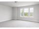Bedroom featuring plush carpet and three large windows that provide natural light at 147 Little Crk Dr, Lillington, NC 27546