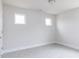 Well lit bedroom showcases two windows, neutral walls, plush carpet, and white trim at 147 Little Crk Dr, Lillington, NC 27546