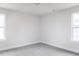 Carpeted bedroom with two windows showcases natural light at 147 Little Crk Dr, Lillington, NC 27546