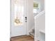 Welcoming entryway featuring a stylish front door and a staircase with carpeted steps at 147 Little Crk Dr, Lillington, NC 27546