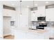 Bright kitchen boasts modern appliances, white cabinets, a stylish island and designer pendant lights at 147 Little Crk Dr, Lillington, NC 27546
