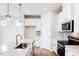 Modern kitchen features stainless steel appliances, stylish white cabinets, and elegant countertops at 147 Little Crk Dr, Lillington, NC 27546