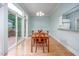 Dining room with hardwood floors, a pass-through window to the kitchen, and lots of light at 1508 W Markham Ave, Durham, NC 27705