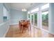 Bright dining area boasts natural light, hardwood floors, and access to an outdoor deck for seamless indoor-outdoor living at 1508 W Markham Ave, Durham, NC 27705