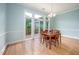 Bright dining room featuring hardwood floors, a chandelier, and sliding glass doors at 1508 W Markham Ave, Durham, NC 27705