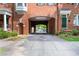 The driveway in this neighborhood leads through a brick archway, offering a charming entrance and unique architectural detail at 1508 W Markham Ave, Durham, NC 27705