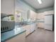 Cozy kitchen featuring white appliances, blue countertops, and ample cabinet space at 1508 W Markham Ave, Durham, NC 27705