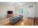 Bright living room featuring hardwood floors, neutral paint, and a large window at 1508 W Markham Ave, Durham, NC 27705